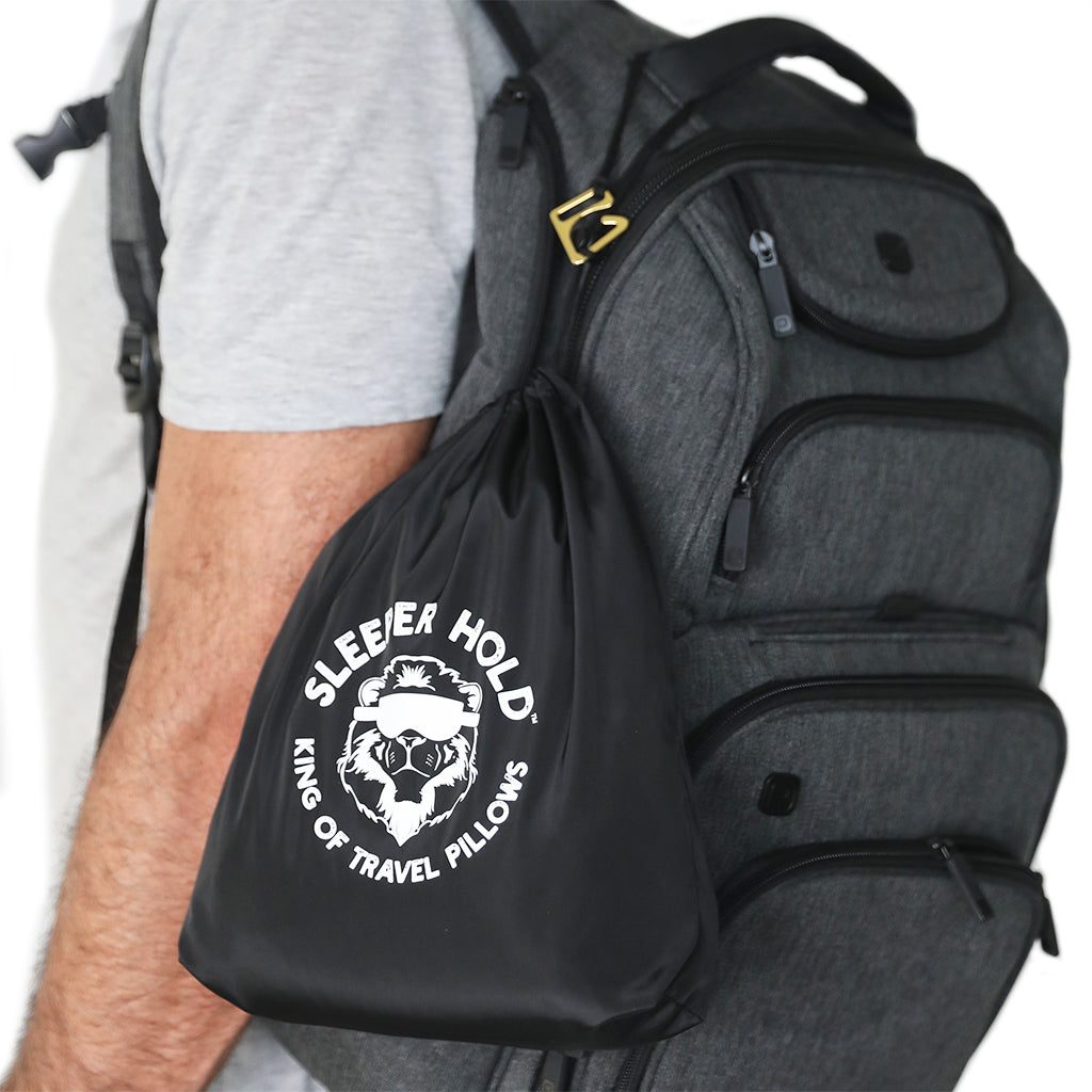 travel pillow attached to backpack compression straps carabiner